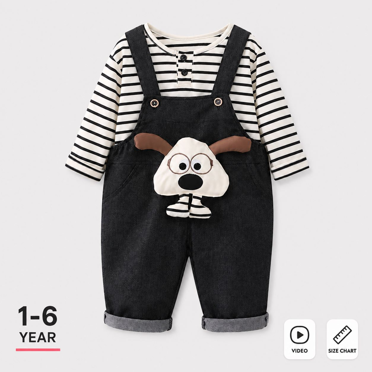 A baby boy's two-piece outfit featuring a black and white striped long-sleeve shirt under dark denim-style overalls with a dog face applique on the front. The image includes '1-6 YEAR' text on the bottom left and 'VIDEO' and 'SIZE CHART' icons on the bottom right, set against a light gray background.