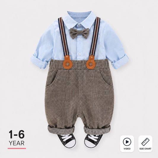 A baby boy's 1-6 year outfit set featuring a light blue long-sleeve collared shirt, brown corduroy suspenders with orange-brown leather-like accents, a gray bow tie, and black-and-white sneakers, displayed on a light gray background with informational text and icons.