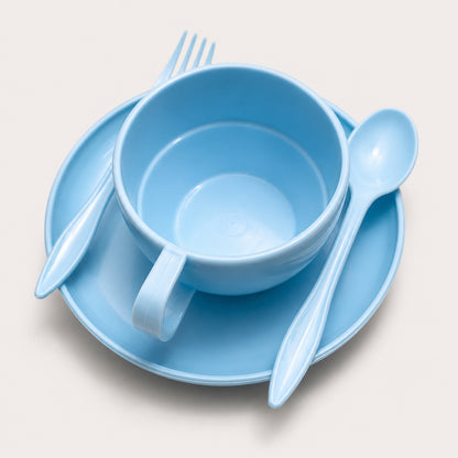 Light blue plastic dinnerware set including a cup, saucer, fork, and spoon, arranged on a light beige background.
