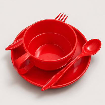 A bright red plastic dinnerware set on a light gray background, including a bowl, matching saucer, cup with handle, spoon, and fork.